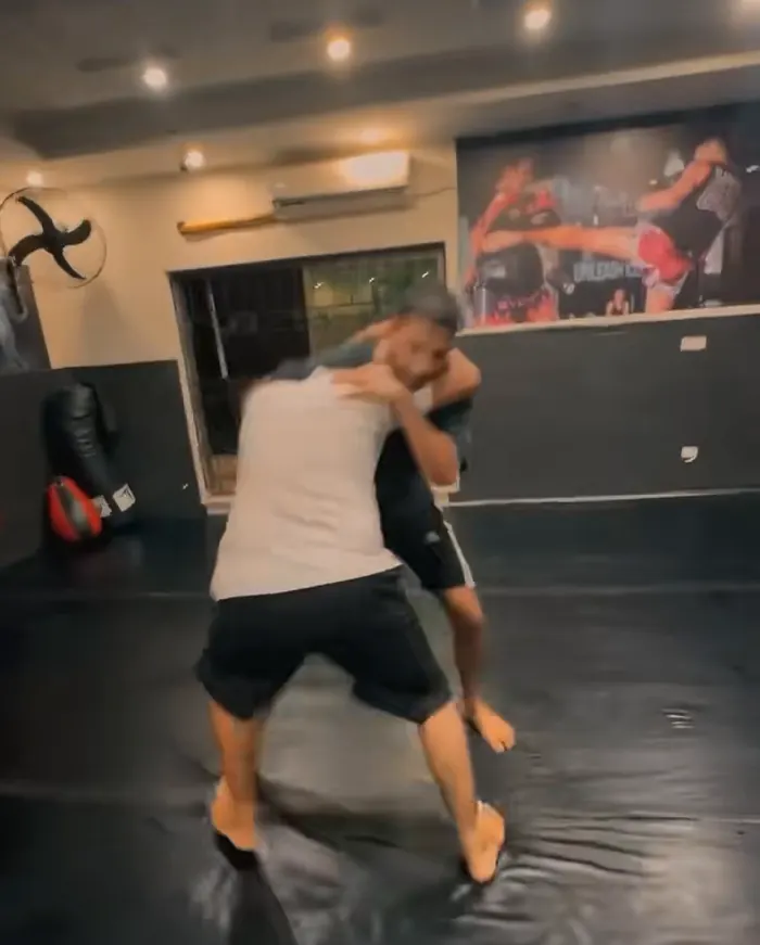Two members grappling on the mats